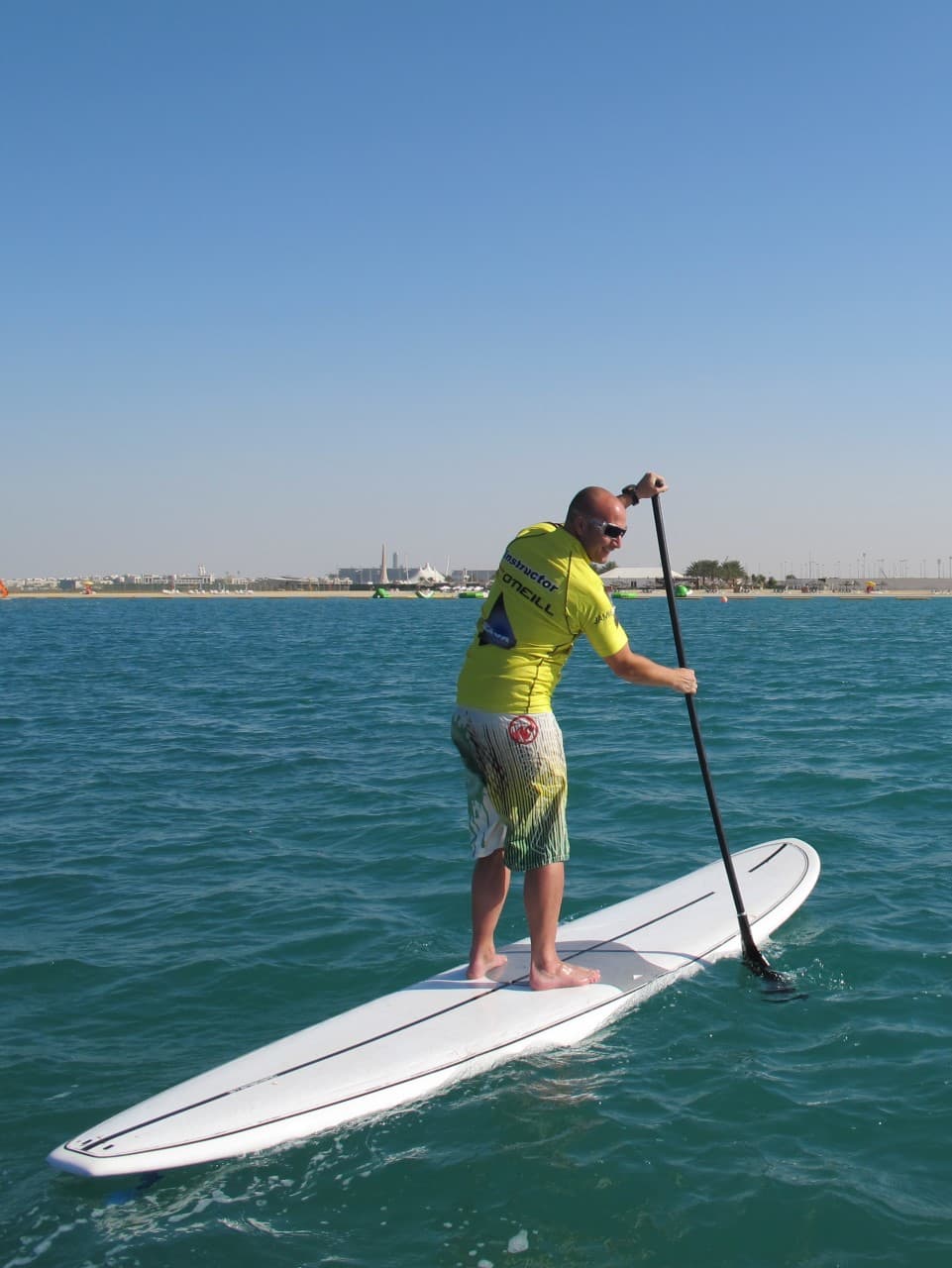 Paddler on a stand-up board at sunrise on the Red Sea.